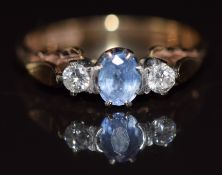 A 9ct gold ring set with an oval cut sapphire and diamonds, 2.2g, size L