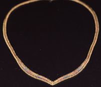 A 9ct gold tri-coloured necklace with V shaped design, 24cm, 10.4g