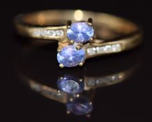 A 14k gold ring set with two tanzanites and diamonds, 1.8g, size L