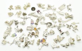 Over seventy silver / white metal charms including dogs, swan, pig, bus, car, boat, etc