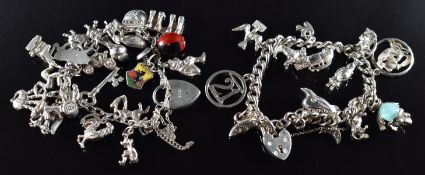 Two silver charm bracelets with over twenty five white metal / silver charms including car, dog,