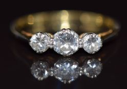 An 18ct gold ring set with three diamonds, the centre diamond approximately 0.3ct, 1.9g, size P