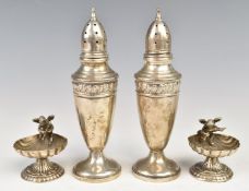 Pair of novelty silver salts by shell shaped bowls surmounted with cherubs, together with a pair