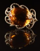 A 14k gold pendant set with a large rose cut citrine measuring approximately 27 x 32mm, surrounded