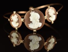 Victorian 9ct gold bangle set with three cameos and seed pearls, 5.2g