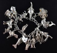 Silver charm bracelet with fourteen silver charms including fish, dolphin, donkey, dog, etc, 79.9g