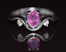 An 18ct white gold ring set with an oval cut pink sapphire of approximately 0.5ct and diamonds, 4.