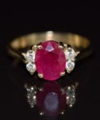 A 14k gold ring set with an oval cut ruby of approximately 1.5ct and four diamonds, 3.4g, size O