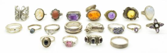 Twenty silver rings including pressed amber, sunstone, garnets, cameo, cubic zirconia, etc