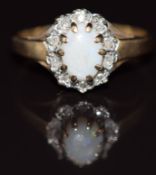 A 9ct gold ring set with an opal cabochon and diamonds, 1.7g, size J/K