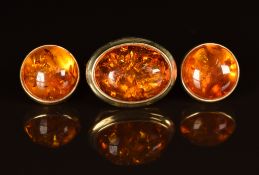 A 9ct gold ring set with pressed amber and a pair of matching earrings, 7.4g