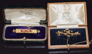 A 15ct gold brooch set with three rubies (3.4g) and an Edwardian 9ct gold brooch set with seed