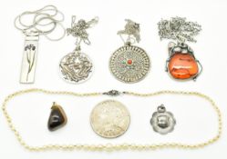 A silver and pressed amber pendant, white metal Thai pendant, silver fob, silver dragon pendant,