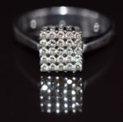 An 18k white gold ring set with diamonds in a square setting, 2.5g, size J