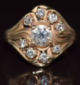 A 14k gold ring set with nine diamonds, the centre diamond approximately 0.7ct, 5.4g, size P