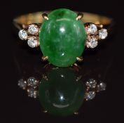 A yellow metal ring set with a jadeite cabochon and diamonds, 3g, size K
