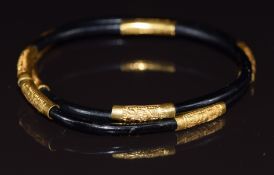 A elephant hair bangle with yellow metal spacers/ mounts