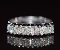 An 18ct white gold ring set with six round cut diamonds, total diamond weight 1ct, 4.1g, size O