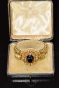 Victorian Etruscan Revival gold bracelet made up of chevron shaped links, the central oval plaque