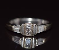 An 18k white gold ring set with four baguette cut and two princess cut diamonds, 2.7g, size I/J