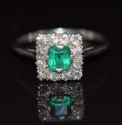 Belle Epoque platinum ring set with an emerald cut emerald of approximately 0.5ct surrounded by