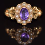 An 18ct gold ring set with an oval cut amethyst surrounded by seed pearls, 3.1g, size L/M
