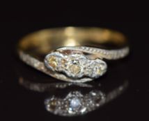 An 18ct gold ring set with three diamonds in a platinum setting, 3g, size P