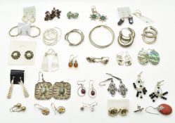 Twenty six pairs of silver earrings including amethyst, abalone, garnet, etc