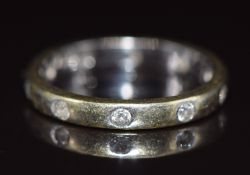 An 18ct white gold eternity ring set with diamonds, 4g, size N/O