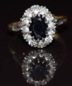 An 18ct gold ring set with an oval cut sapphire surrounded by diamonds, 5.2g, size P