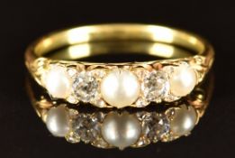 A late Victorian 18ct gold ring set with two old cut diamonds, three split pearls and eight rose cut