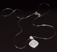 An 18k white gold pendant set with princess cut diamonds and round cut diamonds, total diamond