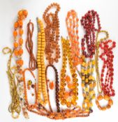A collection of amber, amber style and agate necklaces