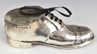 George V hallmarked silver novelty pin cushion formed as a shoe, the cushion hinging open to