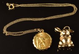 A 9ct gold charm/ pendant in the form of a rabbit, and a 9ct gold St Christopher on 9ct gold
