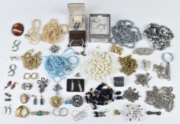 A collection of jewellery including beads and necklaces and silver jewellery including brooches,