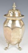 George V hallmarked silver sugar caster of octagonal egg shape, raised on three feet, Birmingham