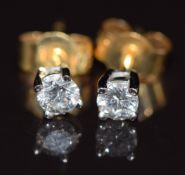 A pair of 18ct gold earrings set with a diamond to each of approximately 0.13ct, 0.9g
