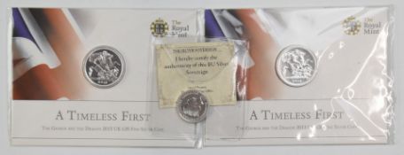 Two Royal Mint 'A Timeless First' 2013 UK fine silver £2 coins, in presentation packs, together with