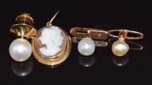 A 14k gold pendant set with a cameo, pearl set tie pin, two cufflinks set with a pearl to each and