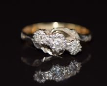 An 18ct gold ring set with three diamonds in a platinum setting, 2.7g, size K