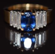 An 18ct gold ring set with a sapphire of approximately 1.3ct and three baguette cut diamonds to each