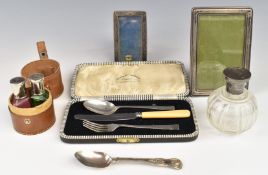 Two hallmarked silver photograph frames, hallmarked topped bottles, silver teaspoon, Christening set