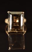 A 9ct gold ring set with an emerald cut smoky quartz, 7.3g, size M