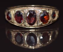A 9ct gold ring set with five garnets, 3.2g, size P