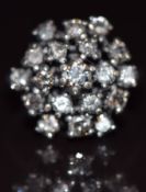 A 14k white gold ring set with diamonds in a cluster, the centre diamond approximately 0.22ct, total