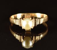 An 18ct gold ring set with a pearl, 2.9g, size Q