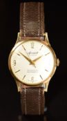 Accurist 9ct gold gentleman's wristwatch with gold hands and hour markers, silver dial and signed 21