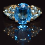 A 9ct gold ring set with oval and round cut blue topaz, 4.8g, size N