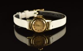 Tissot 18ct gold ladies wristwatch with gold hands and hour markers, cream dial and signed 17